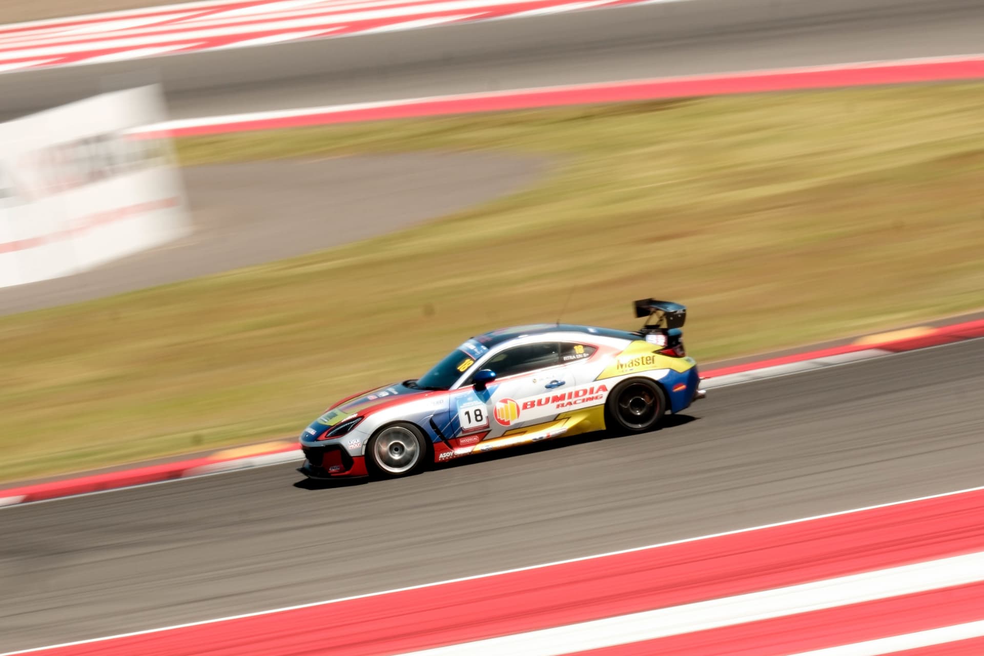 Bumidia Racing BRZ panned at speed past the kerbs